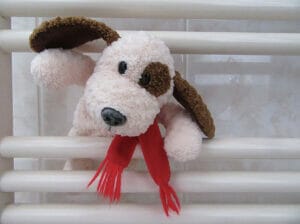 stuffed animal dog with floppy ears and red scarf